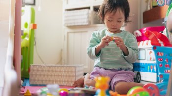 toddler playing with toys and not paying attention to directions