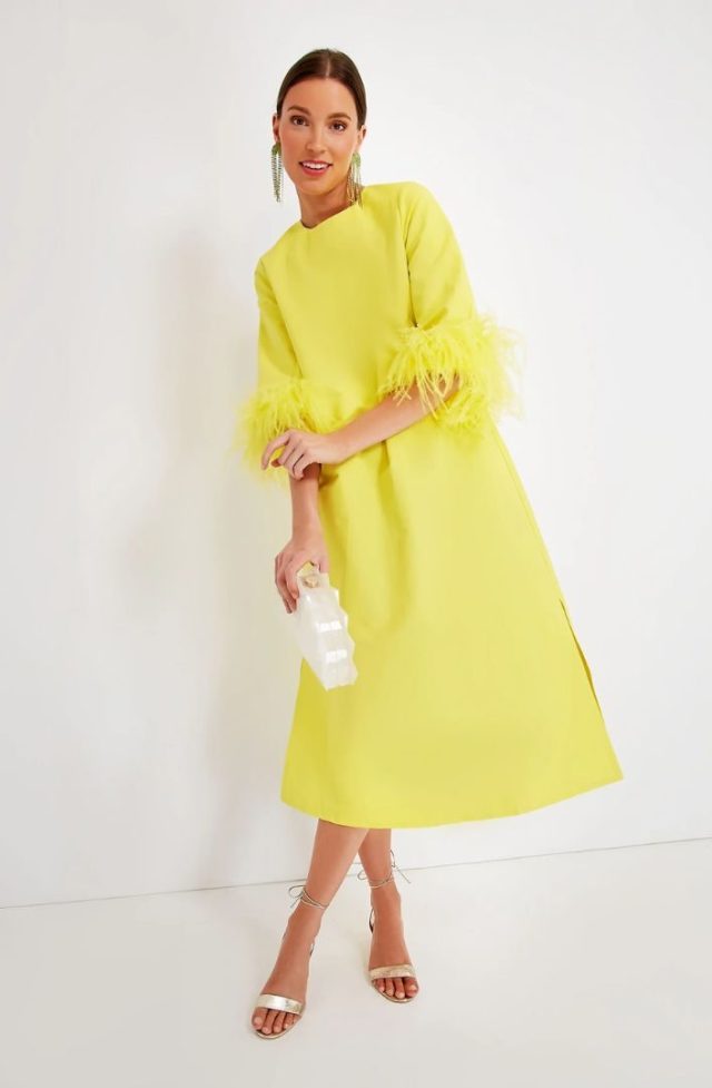 woman in yellow dress with feathered wrist detail