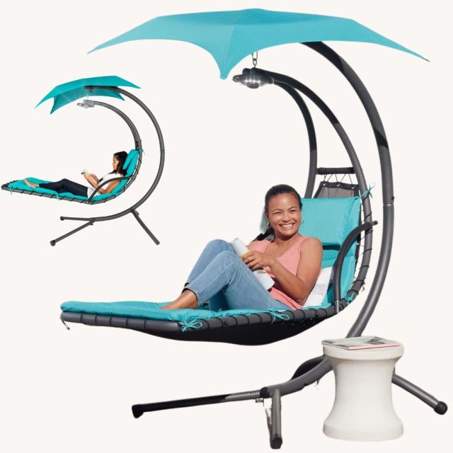 woman reading in outdoor weightless canopy chair swing