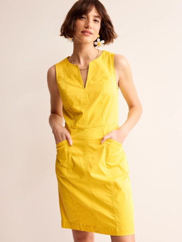 woman wearing yellow shift dress