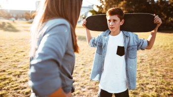 boy holding skateboard