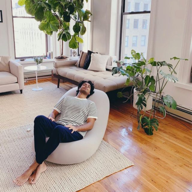 man reclining on Moon Pod bean bag chair