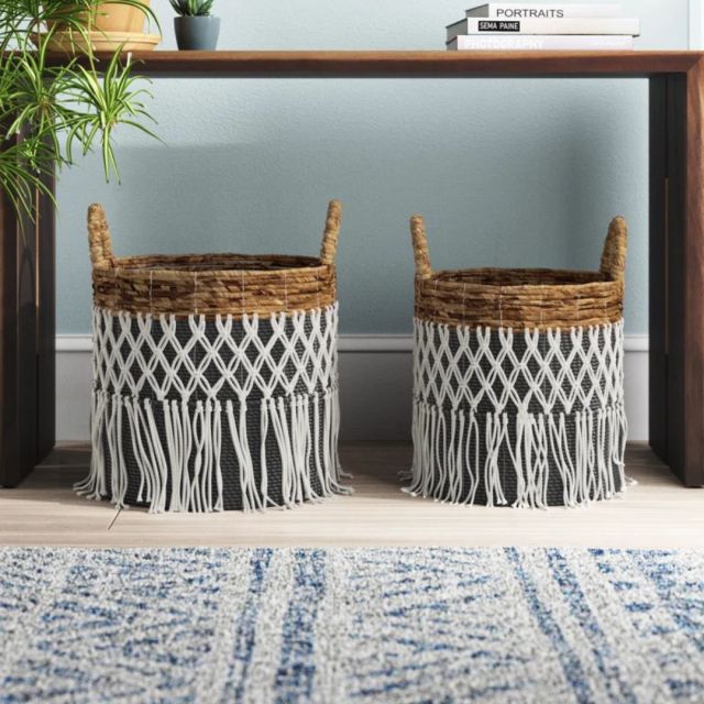 two black wicker storage baskets with tassels