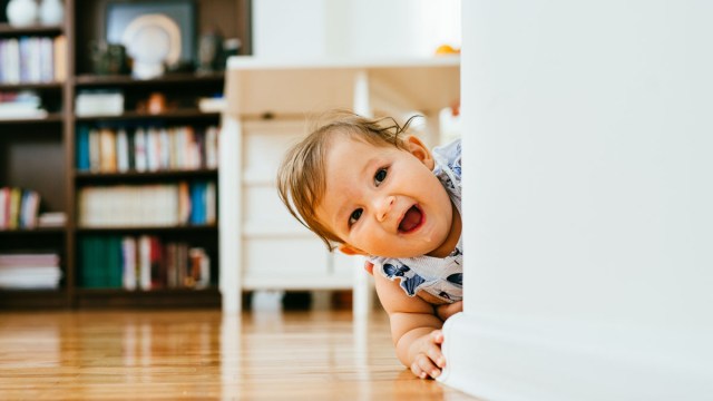 a smiling baby girl who looks like she wants to touch EVERYTHING in the house. Time to read our babyproofing checklist!