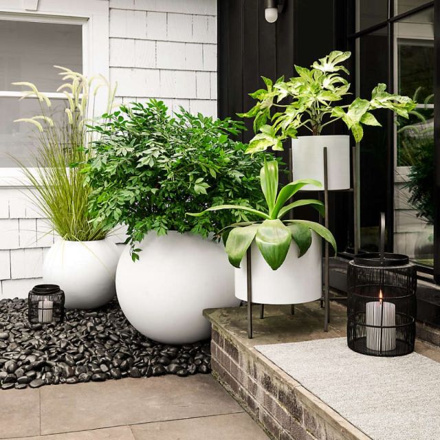 collection of white outdoor planters