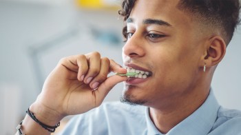 Does chewing gum help your jawline? This teen boy seems to think so as he pops a piece of gum into his mouth