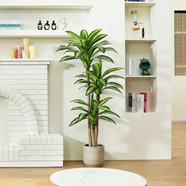 faux Dracaena Tree in living room next to fireplace