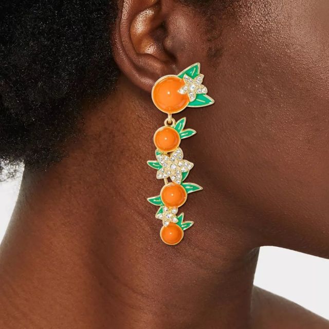 woman wearing orange earrings