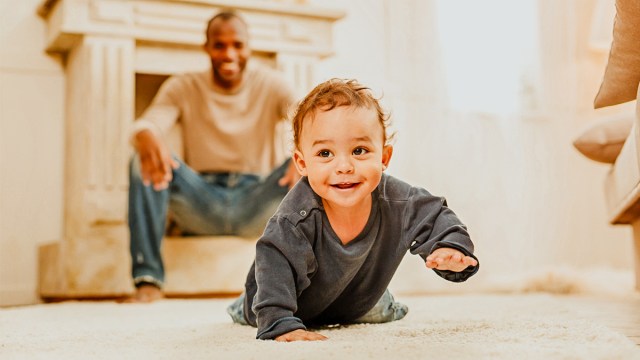 A baby crawling, one of the milestones that a pediatric PT thinks is important