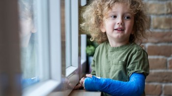 a little boy with a broken arm after doing something an er pediatrician wouldn't recommend
