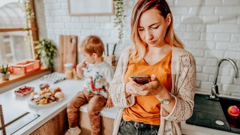 mom looking at social media on her phone