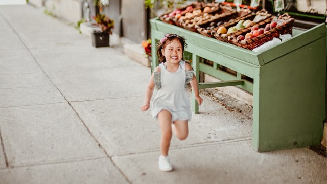 a little girl running down the street before her mom tries some activities to calm kids before public outings