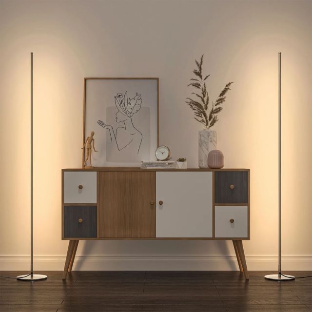 two long floor lamps next to a sideboard table