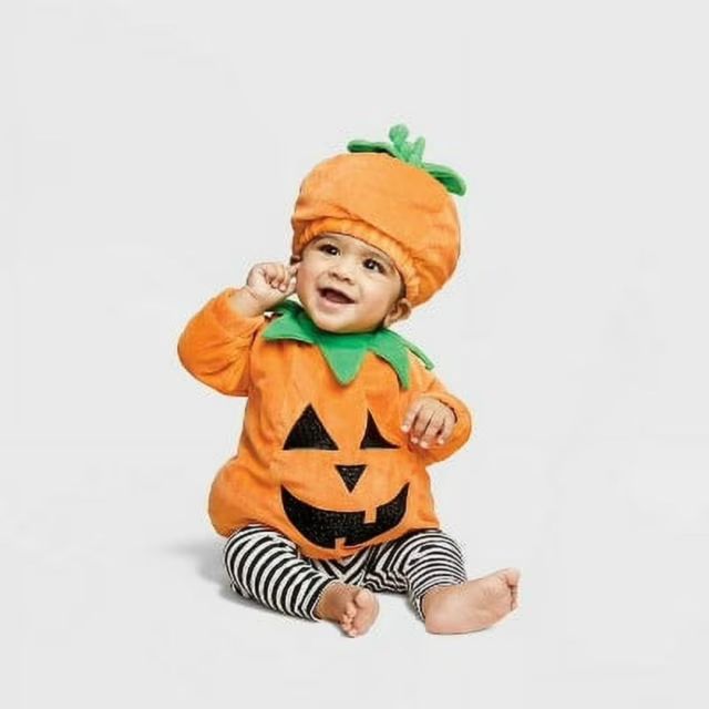 baby wearing pumpkin costume