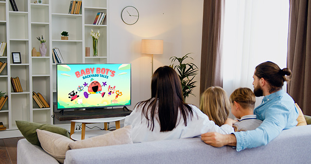 A family watching a Lingokids show on the TV