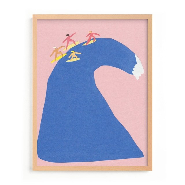 A West Elm Kids piece of wall art for kids called Surf's Up showing a big blue wave on a pink background with surfers at the top