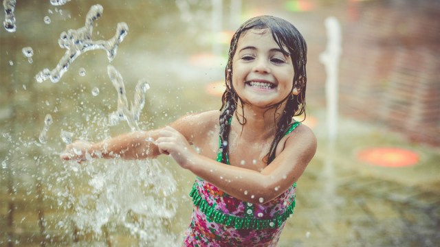 Running through sprinklers is one of the great summer bucket list ideas