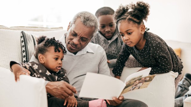 a grandparent appreciating creative photo book ideas with his grandkids