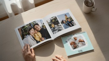 A photo book and calendar from the Tinybeans photo store opened to beautiful spreads