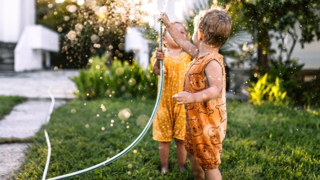 playing with the hose is one of the great outdoor activities for toddlers