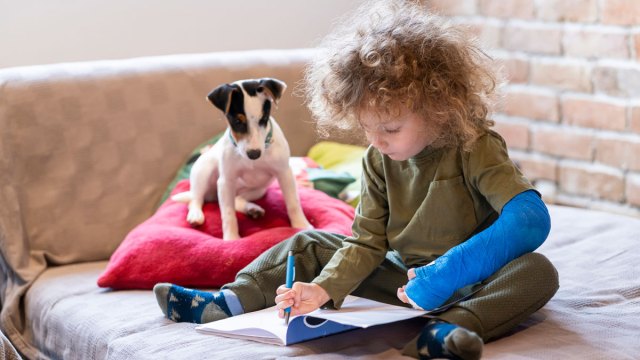 a little boy with a broken arm after doing something an er pediatrician wouldn't recommend