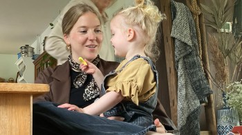 A mom laughing with her toddler while following a digital detox for parents