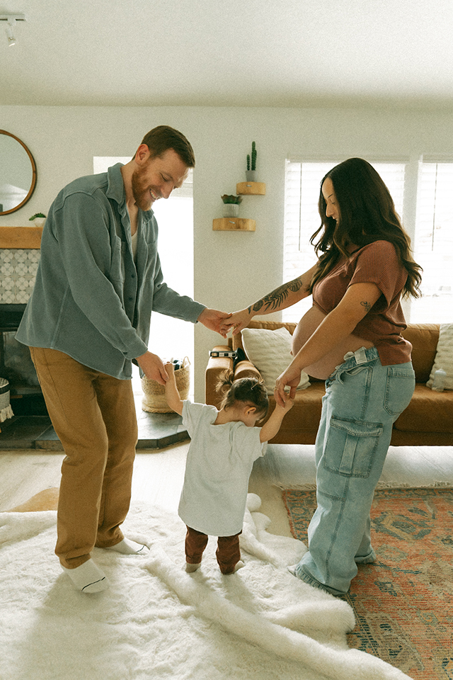 A couple and their toddler having a dance party, one of the best faceless photo ideas