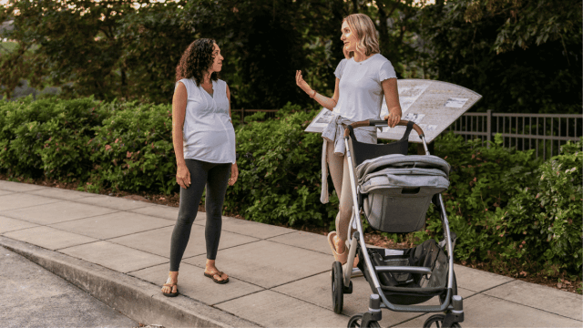 mom friends hanging out, one pregnant and the other with a stroller