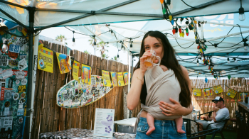 Writer Fortesa Latifi, who is an expert on family influencers, wearing her baby at a beer garden